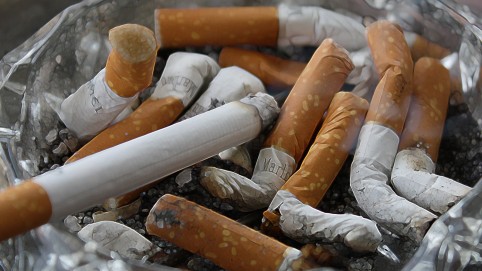 A bunch of cigarette butts in an ashtray