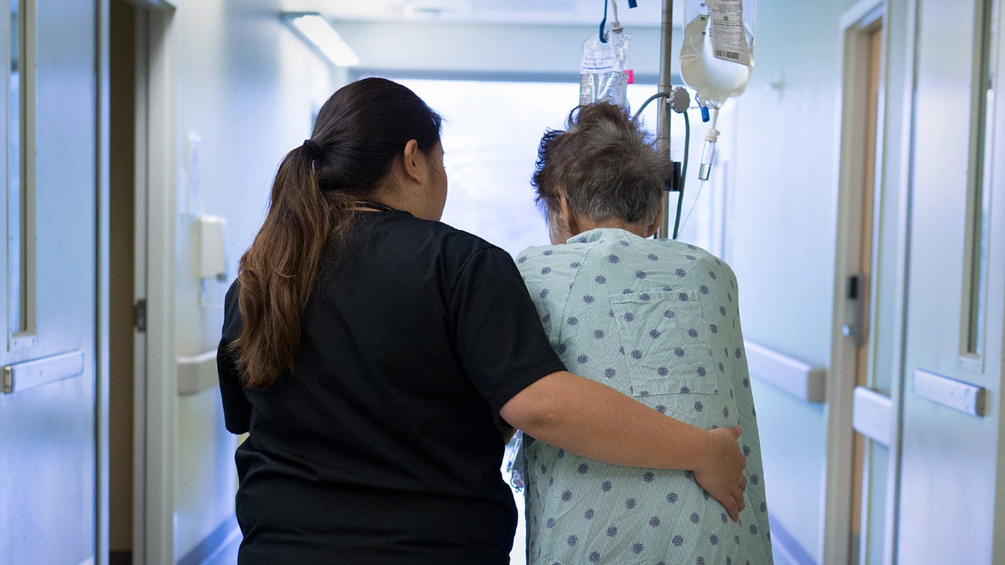 A registered nurse assists an elderly patient