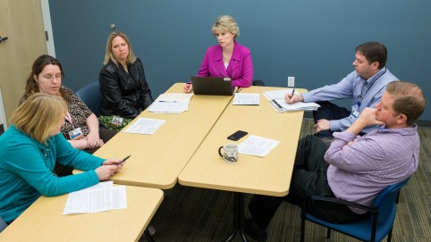 group of people sitting around a conference table