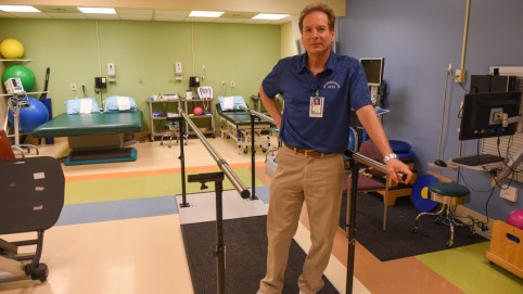 Man standing in a rehab gym