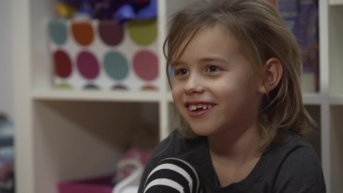 A cute little blonde girl smiling